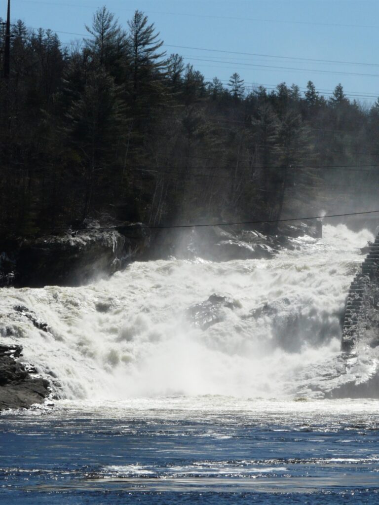 Water flowing down from a dam which can have calming health benefits of hiking